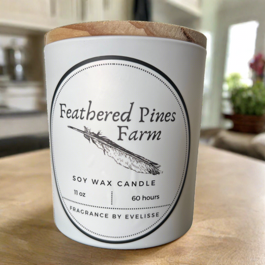 Feathered Pines Farm candle sitting on a countertop in a white farmhouse kitchen